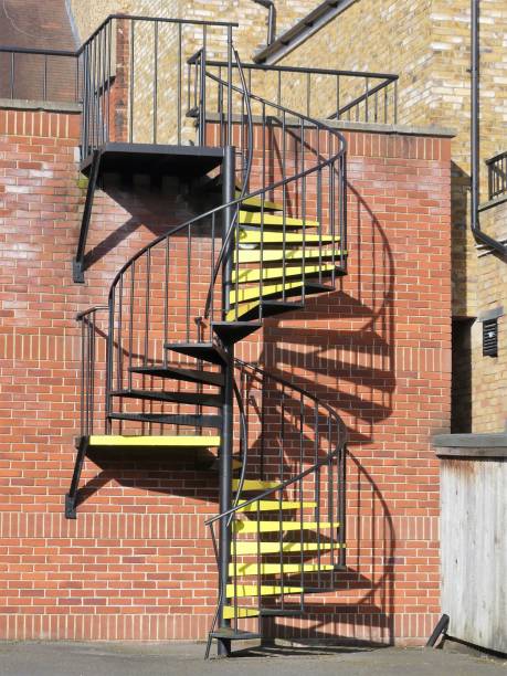 istock Metal spiral staircase with yellow steps 1131408520