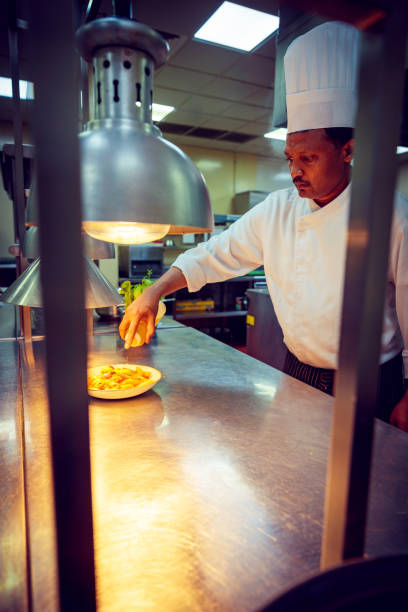 istock Professional Chef Garnishing the Freshly Cooked Pasta 1131408613