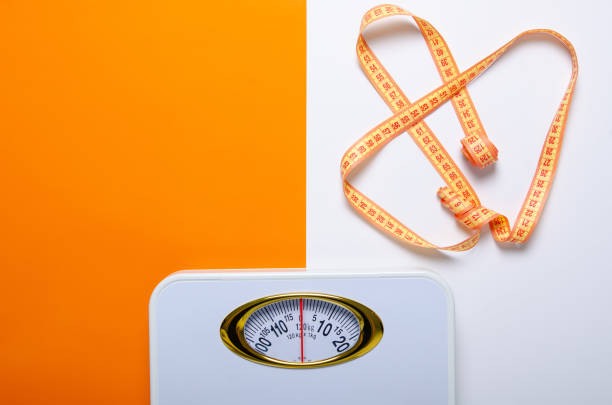 istock bathroom weigh scale and measuring tape 1131409578