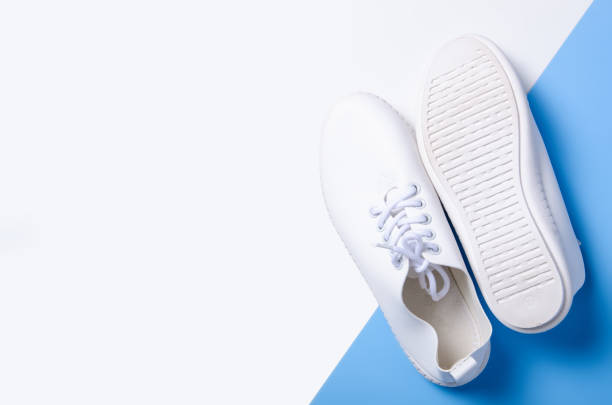 istock Pair of white sneakers and space for text 1131409602