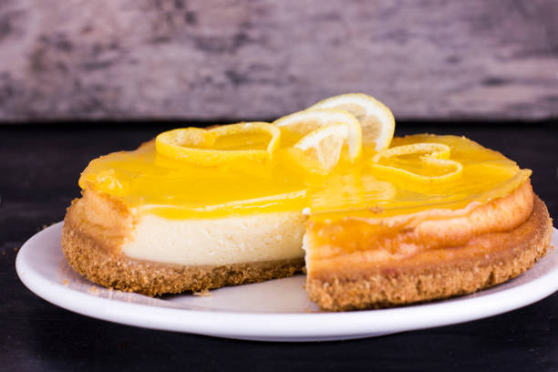 istock Lemon cheesecake on black background decorated with lemon zest close up 1131410353