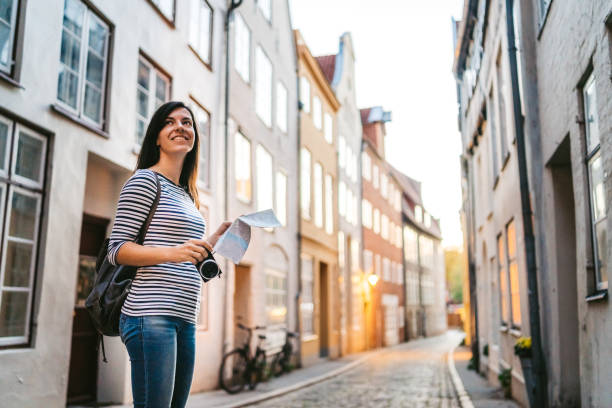 istock Woman exploring Lubeck old town 1131410604