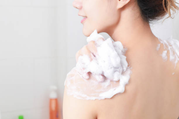 istock Midsection Of Woman Applying Soap On Back 1131411411