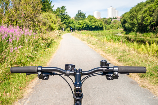 A commuter cyclist's point of view of the shared footpath and cycle lane along the Forth and Clyde Canal, taken during summer.