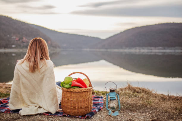 istock Young woman enjoying by the lake 1131411664