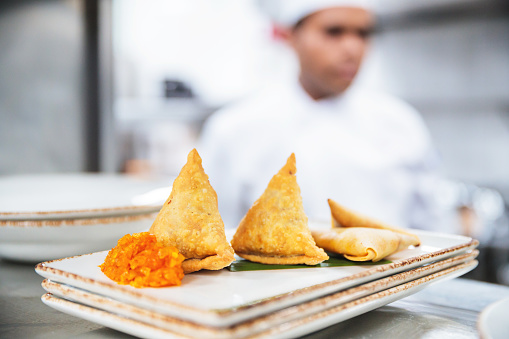 Chefs, Restaurant, Fine Dining, Professionals, Dubai - Samosas with Condiments Cooked in a Commercial Kitchen Awaiting Server