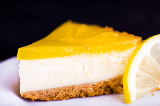 istock Lemon cheesecake on black background decorated with lemon zest close up 1131413150
