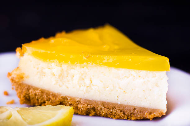 istock Lemon cheesecake on black background decorated with lemon zest close up 1131413441