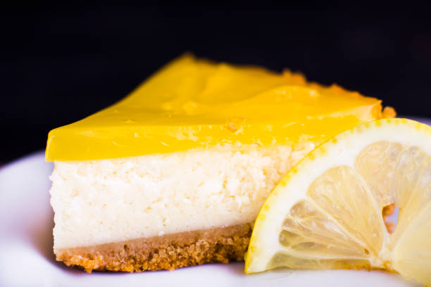 istock Lemon cheesecake on black background decorated with lemon zest close up 1131414303