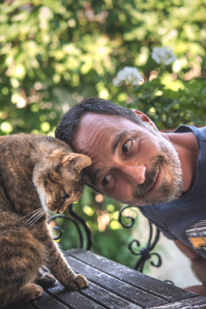 istock Handsome Bearded Man Cuddling with his Cat 1131414638