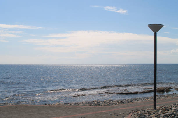 istock Lamp post on a sidewalk by the sea 1131414650