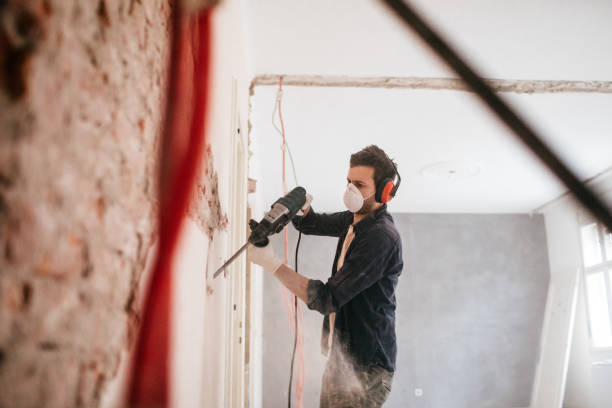 istock Man using drilling machine during reconstruction of his apartment 1131419907