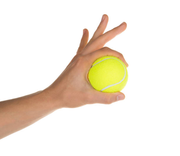 istock hand holding tennis ball isolated on white clipping path 1131420186