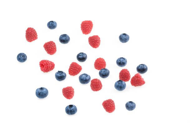 istock Raspberries and blueberries white background top view 1131420202