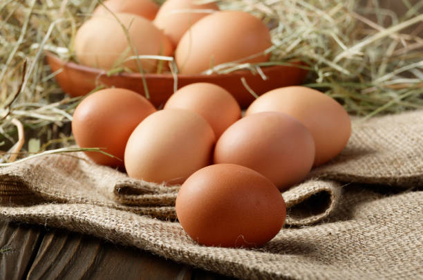 istock Fresh brown organic chicken eggs on wooden table and hemp burlap 1131421057