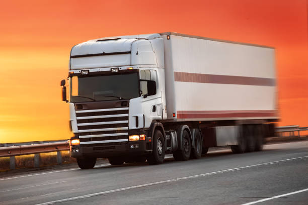 istock truck goes on highway on sunset 1131421675