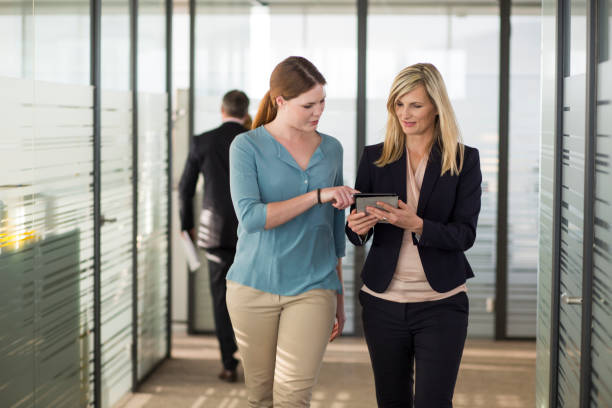istock Coworkers talking in an office coridor 1131424382