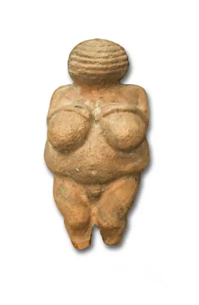 Replica of Venus of Willendorf, Old Stone Age famous sculpture. Isolated over white