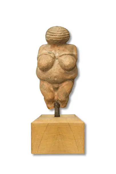 Replica of Venus of Willendorf, Old Stone Age famous sculpture. Isolated over white