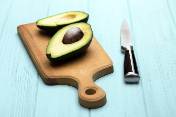 istock avocado on cutting board on blue background