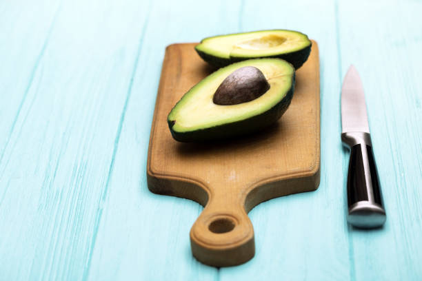 istock avocado on cutting board on blue background