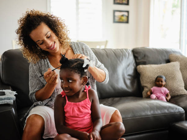 istock Mom and Daughter Doing Hair 1131428286