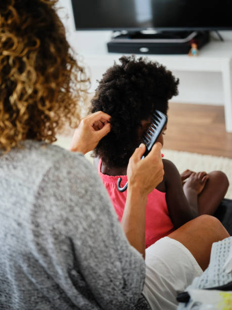 istock Mom and Daughter Doing Hair 1131428290