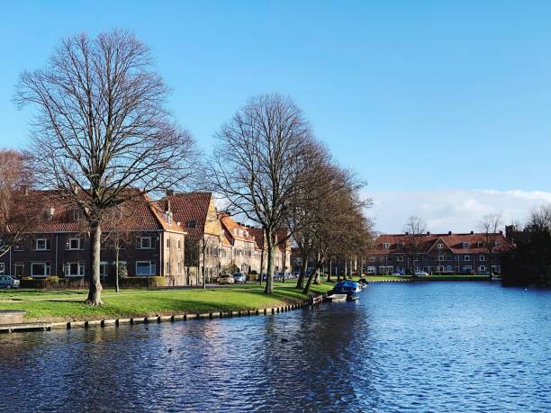 istock River Amidst Houses And Trees Against Blue Sky 1131428461
