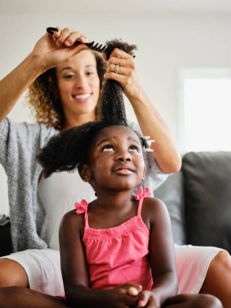 istock Mom and Daughter Doing Hair 1131428469