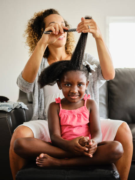 istock Mom and Daughter Doing Hair 1131428677