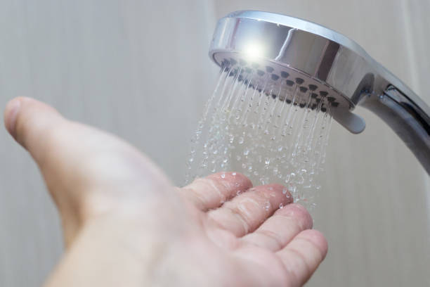 istock hand in the shower test water temperature 1131429168