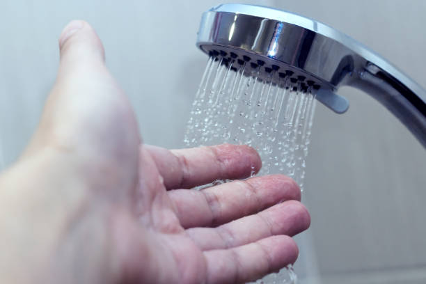istock hand in the shower test water temperature 1131429731