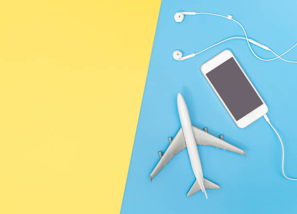 istock Travel objects with empty mobile flatlay on blue with yellow pink copy space 1131430136