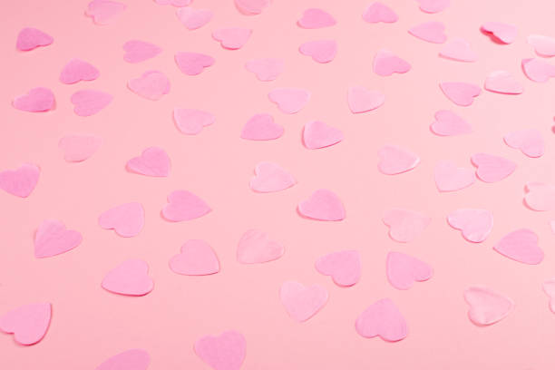 istock Pink background with heart-shaped confetti. 1131437070