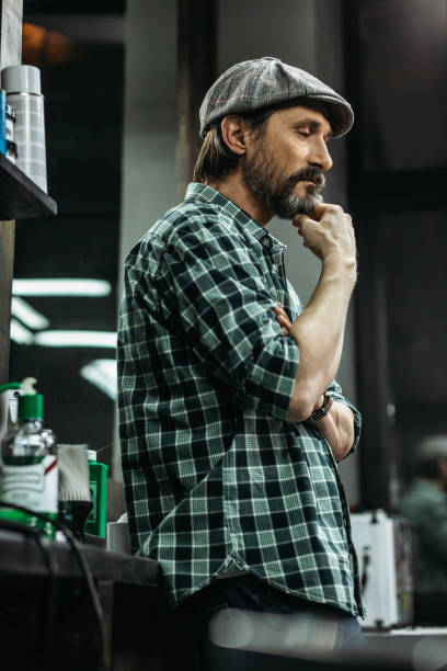 istock Waist up thoughtful man touching his chin and looking down 1131438842