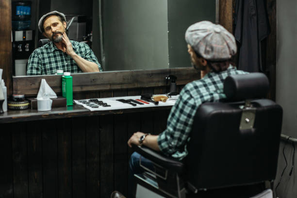 istock Barbershop visitor sitting and looking at his reflection 1131438855
