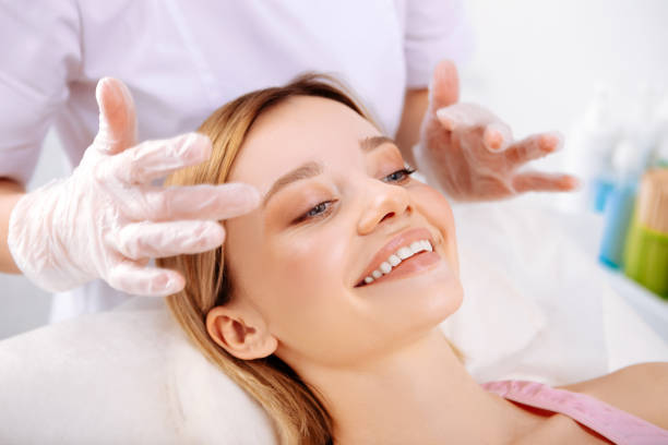 istock Cosmetologist making face massage of beautiful smiling client 1131440264