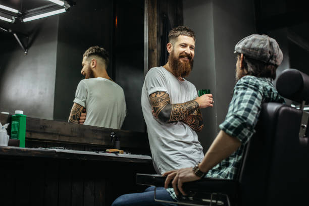 istock Positive bearded barber looking at his client and smiling 1131442214