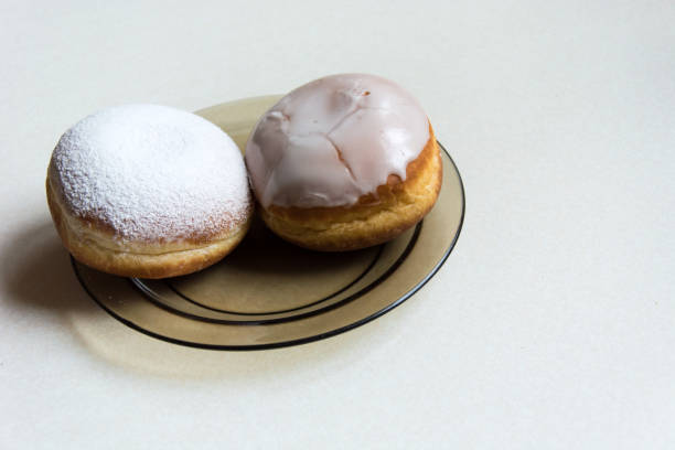 istock Donuts with icing and powdered sugar on a plate 1131442956