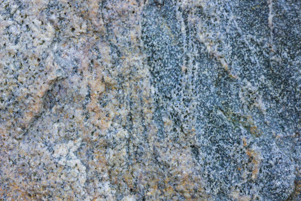 istock Granite texture close up. Granite rocks with porous surface. Background from solid stone. Pattern with natural material 1131444970