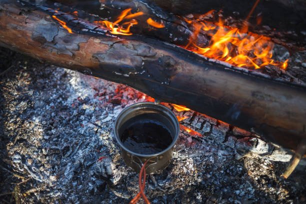 istock Metal Cup with tea is heated from the campfire in winter 1131445520