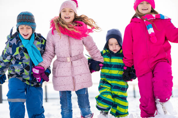 istock Group of kids running on snow 1131447568