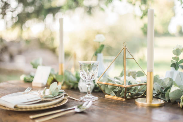Gold and pastel wedding dinning table decoration. Geometic shapes, rustic decor, eucalyptus branches, candles, menu. Bokeh background. Inspiration for wedding table decoration in boho and rustic style. eucalyptus tree photos stock pictures, royalty-free photos & images