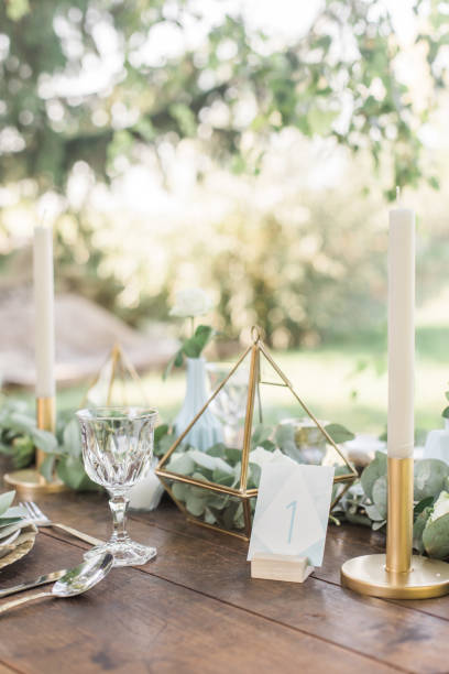istock Wedding decor for elegant table setup in gold and blue pastels for a tuscany style wedding, eucalyptus greenery and geometric decoration. vertical Imagei 1131449294