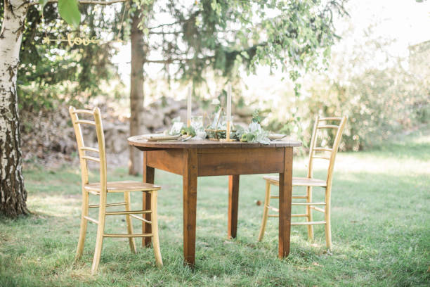 istock Gold and pastel wedding dinning table decoration. Geometic shapes, rustic decor, eucalyptus branches, candles, menu. Bokeh background. 1131449301
