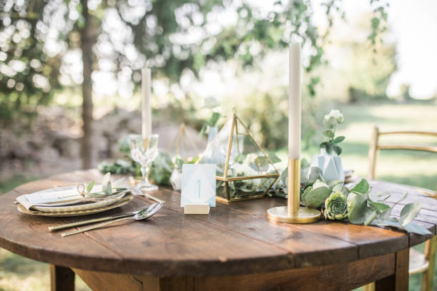 istock Luxury wedding reception dining table setup with eucalyptus branches and gold geometric decoration on a rustic wooden table 1131449341
