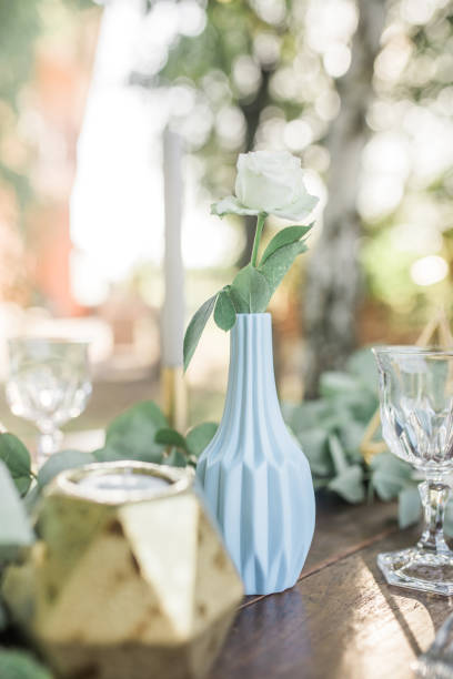 Wedding decor for elegant table setup in gold and blue pastels for a tuscany style wedding, eucalyptus greenery and geometric decoration. vertical Imagei Decoration for wedding dining table for rustic style wedding art deco vase stock pictures, royalty-free photos & images
