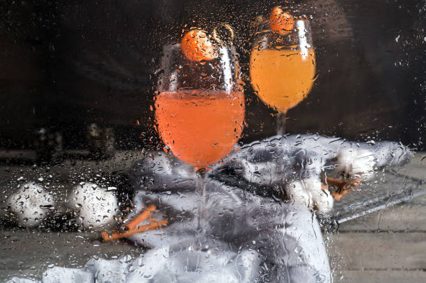 istock Orange cocktails on gray background 1131451250