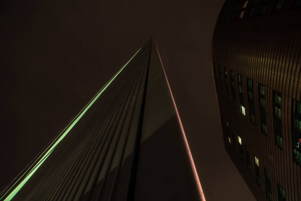 London, United Kingdom - February 10, 2007: Regular lines of More London Place building (designed by Foster and Partners) shine at night. Example of modern architecture in UK capital.