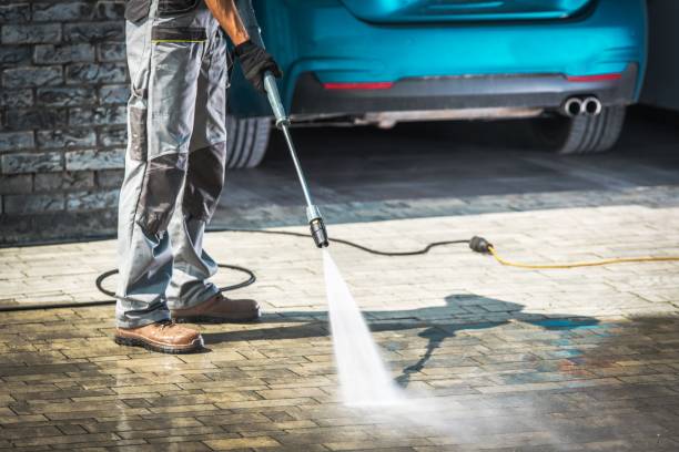 Cobble Driveway Washing Cobble Driveway Pressure Washing by Caucasian Worker. driveway stock pictures, royalty-free photos & images
